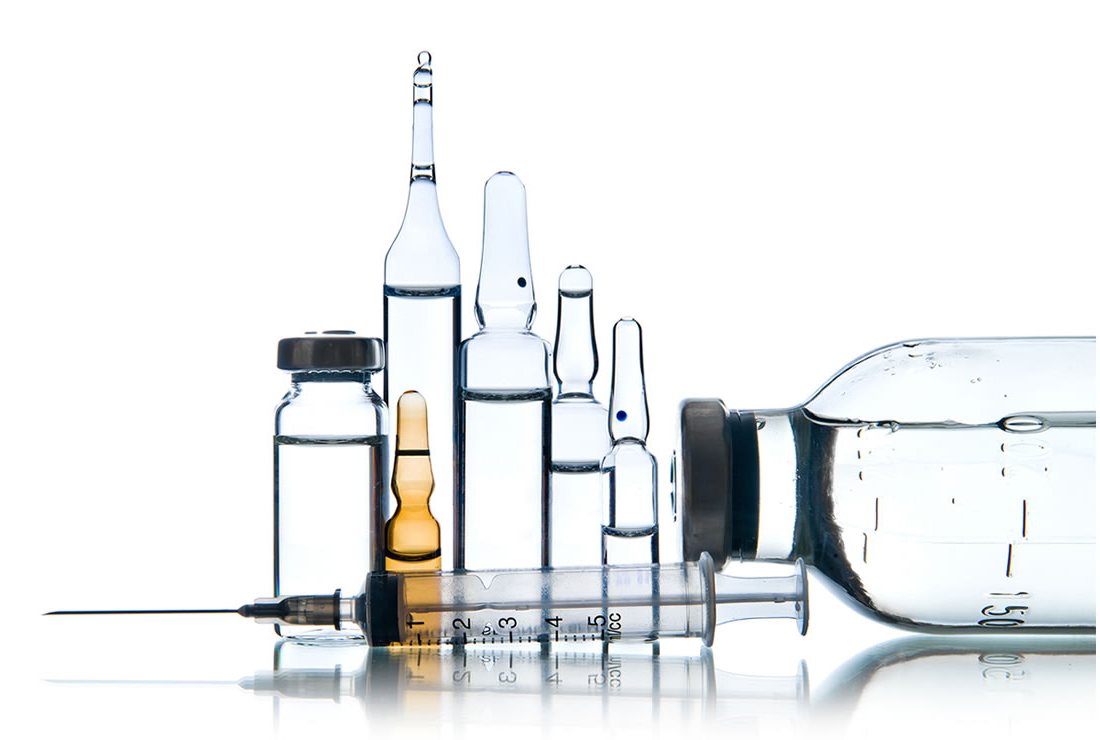 Glass Ampoules and Vials with a syringe on a white surface